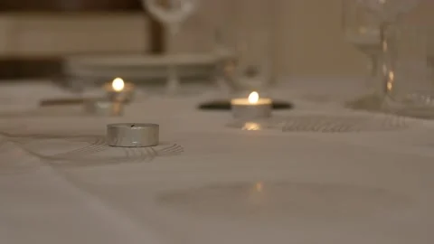 Romantic evening with candles. A single candle is lit, while other candles in Stock Footage 145777301