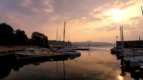 Romantic Evening Glow Within Intimate Lakeside Harbor Scene Stock Footage 327057664