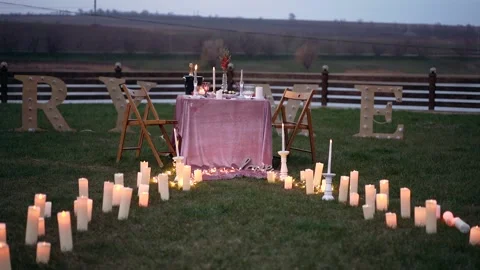 Romantic evening setting, the candles that form a path, at the ends of which Stock Footage 155628411