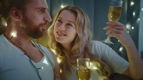 Romantic evening with sparkling drinks and twinkling lights indoors Stock Footage 303799530