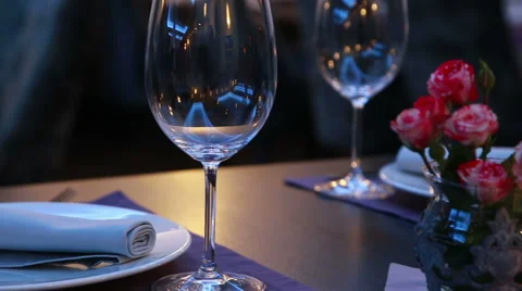 Romantic expensive table serving with wineglasses, plates and roses Stock Footage 48622171