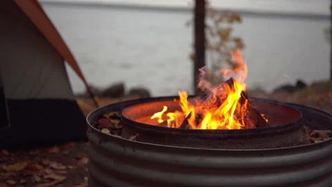Romantic fall camping along lakefront at night Stock Footage 162517923