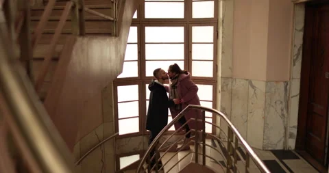 Romantic farewell of lovers on the steps of an old apartment building Stock Footage 247282160