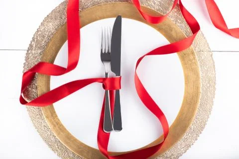 Romantic festive dinner with white empty plate with cutlery Stock Photos