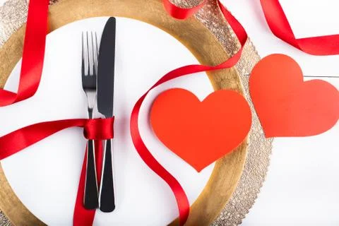 Romantic festive dinner with white empty plate with cutlery Stock Photos