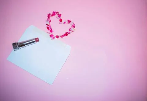 Romantic Flat Lay with Envelope, Lipstick, and Petal Heart Stock Photos
