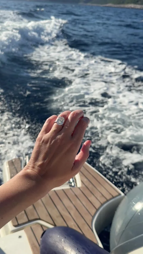Romantic hand with engagement ring touching yacht rail on sunny day Video stock 318335045