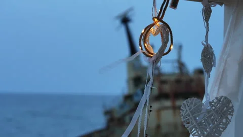 Romantic heart-shaped decorations with a shipwreck in the background Stockbeeldmateriaal 340339614
