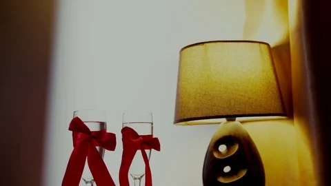 Romantic Interior: dim lights, candles, two glasses of champagne Video stock 71297144