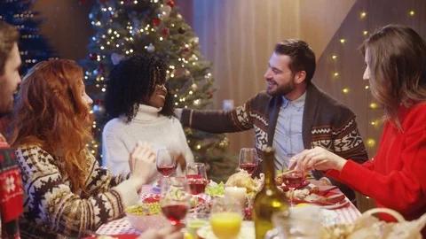 Romantic interrace couple embracing each other while sitting with friends at Stock Footage 121592945