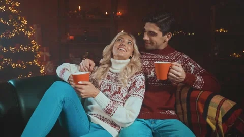 Romantic lady guy sit sofa drink eggnog x mas indoors ornament lights Stock Footage 167077600