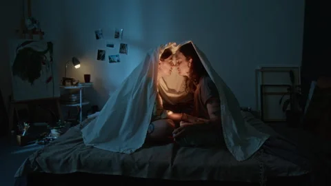 Romantic Lesbian Couple Sharing Intimate Moment under Blanket on Bed Stock Footage 345208441