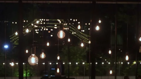 Romantic Lighting Enhances Evening Setting, Decorative Globe Lights Establish 스톡 동영상 323772249