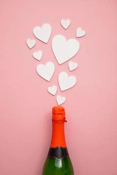 Romantic love hearts exploding from a bottle of champagne 库存照片