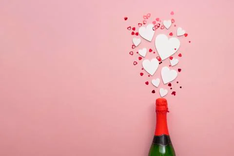 Romantic love hearts exploding from a bottle of champagne Stock Photos