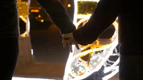 Romantic lovers holding hands outside at the Christmas market Stock Footage 72546465