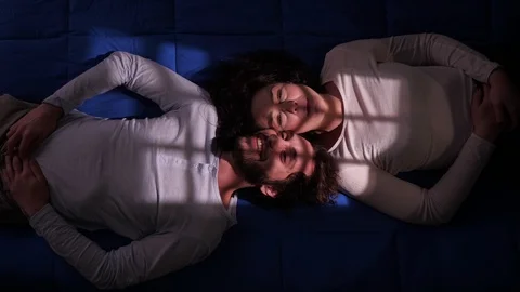 Romantic lovers talking lying on bed at nigth.Love,intimacy,romance-top view Stock Footage 103536341