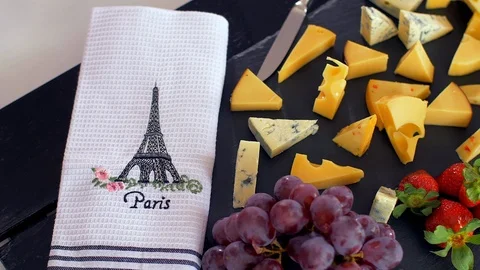 Romantic lunch in Paris. Different types of cheeses on black stone and champagne Stock Footage 109126615