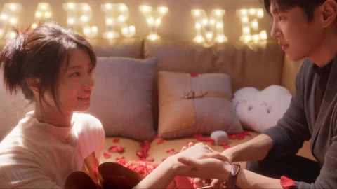 Romantic man putting engagement ring on girlfriend's finger Stock Footage 333799359
