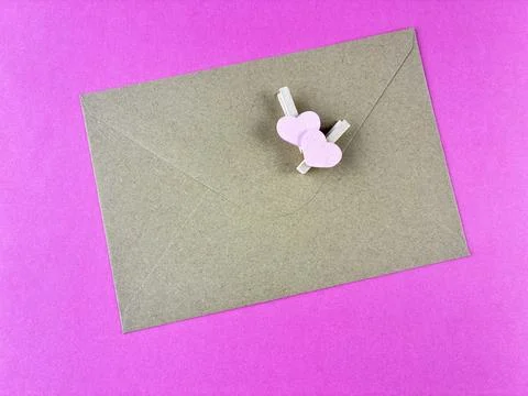 Romantic Message Concept with Brown Paper Envelope and Pink Heart Pegs Stock Photos