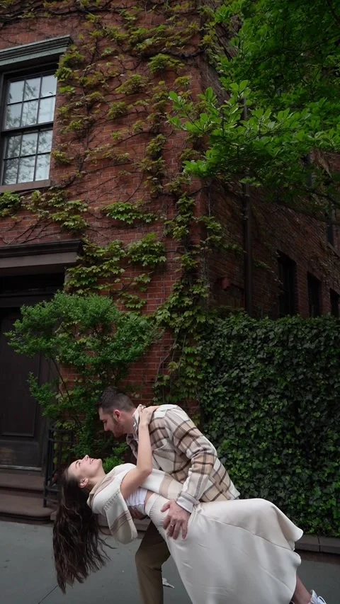 Romantic Moment: Couple Dancing on Sidewalk Near Ivy-Covered Building Video stock 291320570