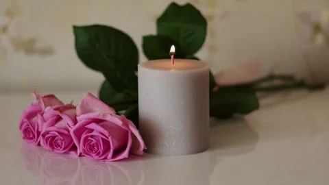 Romantic mood - hand lighting a candle near pink roses Video stock 338193514