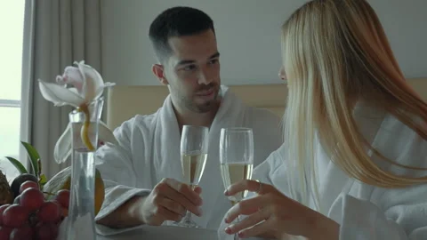 Romantic morning moments shared between a couple in a cozy hotel room Stock Footage 321614239