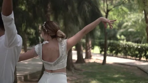 Romantic Newly Married Couple Dancing Chacha in a Garden on their Wedding Day 3 Stock Footage 143940503