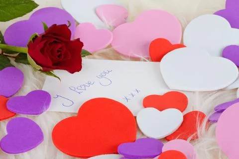 Romantic note: i love with red rose and hearts Stock Photos
