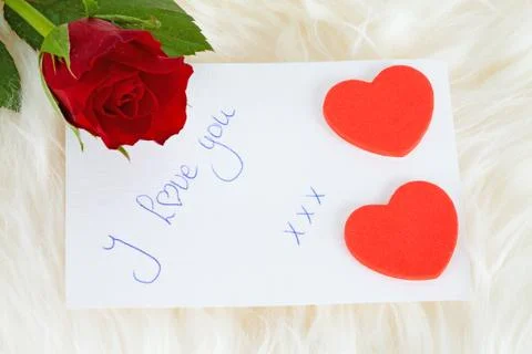 Romantic note: i love with red rose and hearts Stock Photos