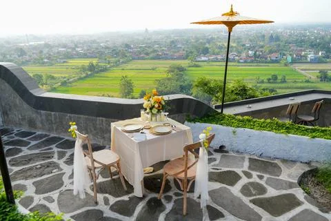 Romantic outdoor dining table for two decorated with yellow flowers. Stock-Fotos
