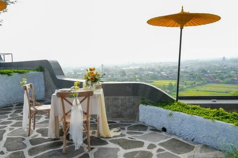 Romantic outdoor dining table for two decorated with yellow flowers. Stockfoto's