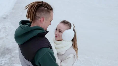 Romantic partners hugging closely while standing on frozen lake surface Stock Photos