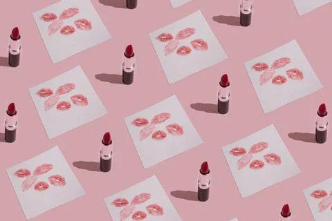 Romantic pastel pink pattern made of red lipstick and paper with kisses. Tren Stock Photos