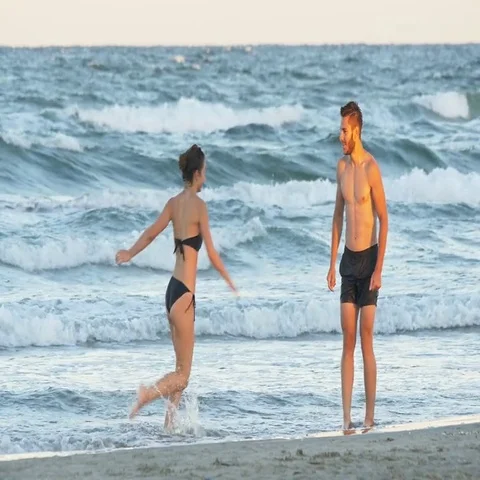 Romantic perfect couple playing on the beach Stock Footage 69699692