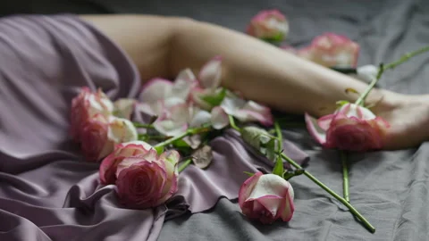 Romantic picture of preparing a date - tender legs and rose flowers Stock Footage 151672534