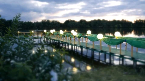 Romantic pier with lanterns on the lake Stock Footage 93784189