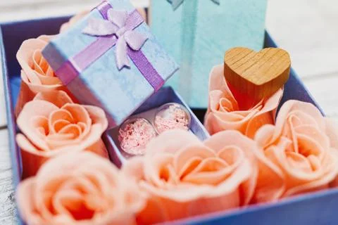 Romantic present idea, box with roses and gift box Stock Photos