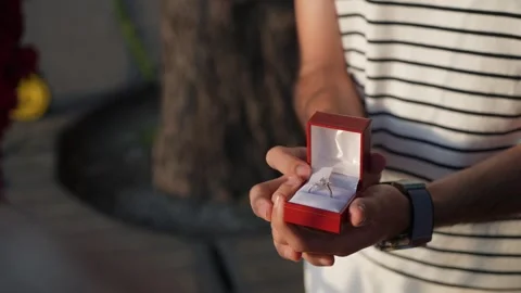 A Romantic Proposal with a Beautiful Engagement Ring Presented in a Stunning Red Video stock 314575779