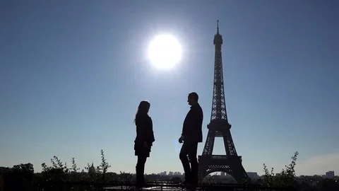 Romantic proposal close Eiffel tower, man on knees, sun shinning on blue sky Stock Footage 69181929