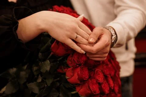 Romantic Proposal Moment with Diamond Ring and Red Roses Held by Loving Cou.. Stock Photos