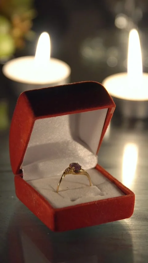 Romantic proposal scene with gold engagement ring in a red velvet box Stock Footage 341678853