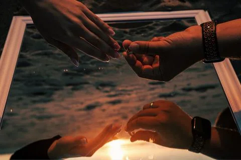 Romantic Proposal at Sunset with Mirror Reflection Stock Photos