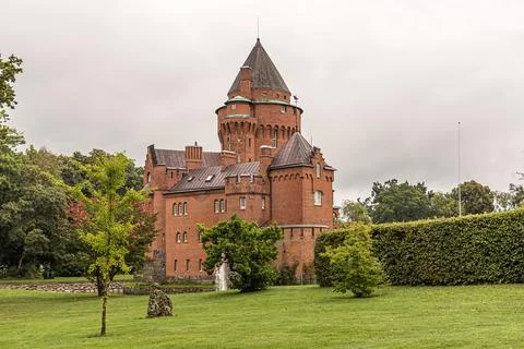 A romantic red castle built by bricks with a tall tower Stock Photos