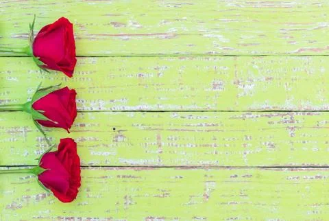 Romantic red roses border background on rustic wood Stock Photos