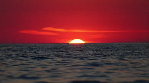 Romantic red sunset over ocean horizon, telephoto Italy landscape in 4K slow Stock Footage 332302723