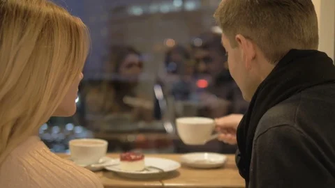 Romantic relationship. A young couple is in a cafe. Video stock 82923749
