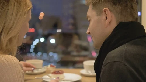 Romantic relationship. A young couple is in a cafe. Video stock 82923902