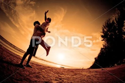 Romantic scene of couples on the beach Stock Photos