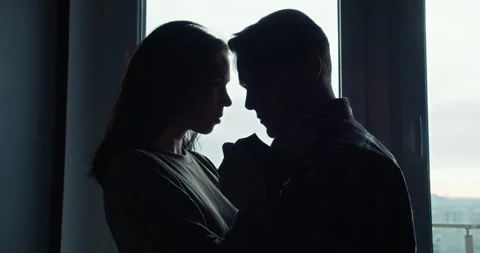 Romantic scene silhouettes of a guy and a girl hugging each other and tenderly Stock Footage 305791598